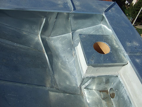 Connection of roof, wall and chimney flashing.