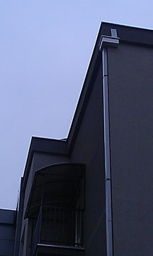 Detail - connection of vertical gutter and water collector on the building.